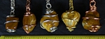 Yellow Jasper stones wire wrapped pendants on necklaces. YellowJ Jasper stones are opaque yellow stones that usually have swirls of brown, tan, and white.